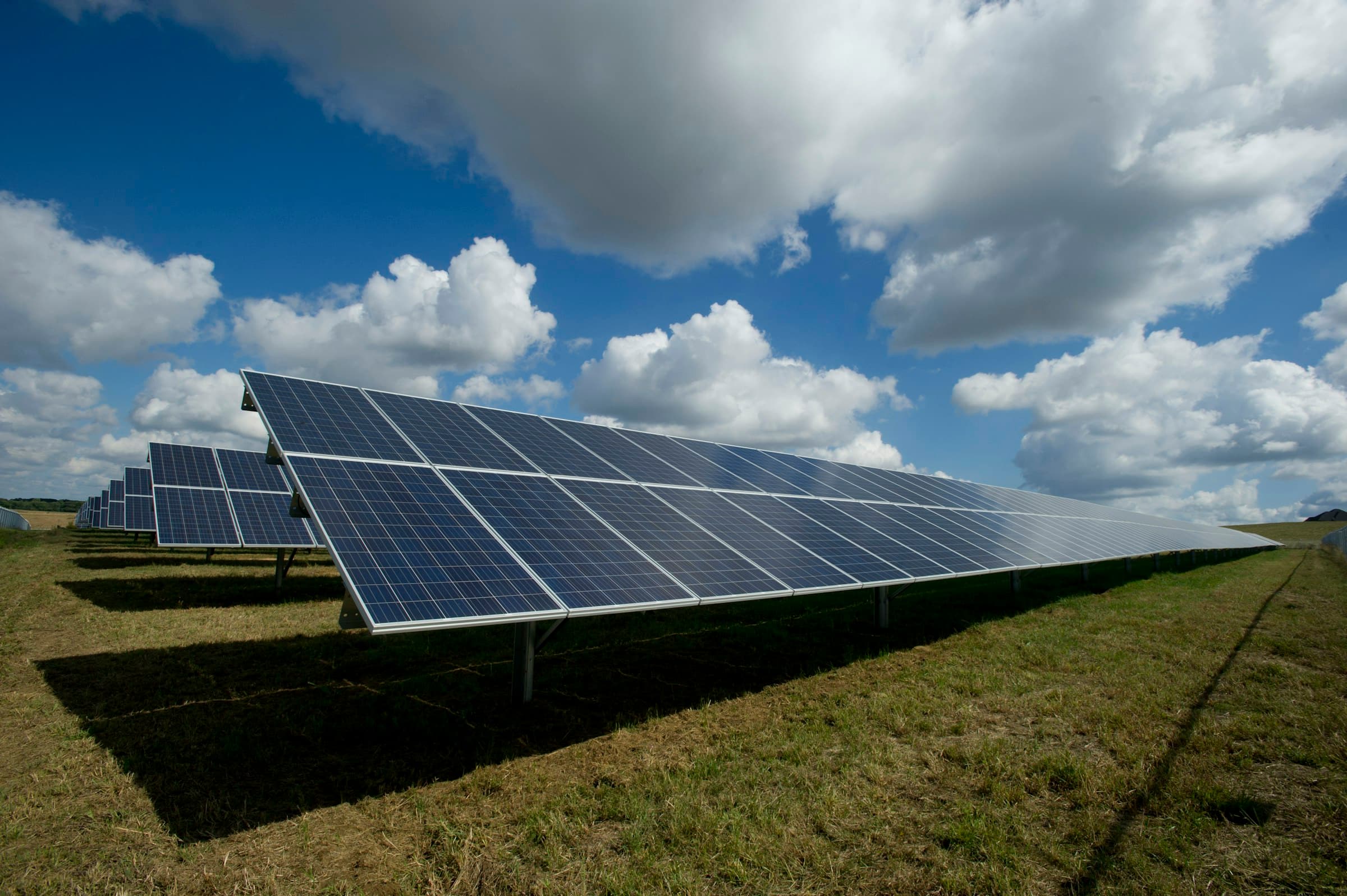 Utility field technician inspecting renewable or grid infrastructure in a safety-focused outdoor operations context